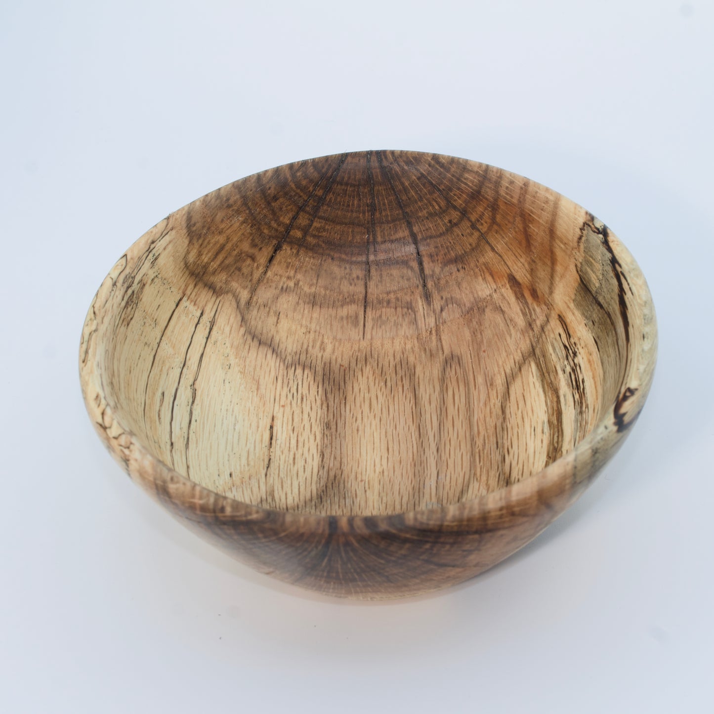Wooden bowl with a natural finish on a white background