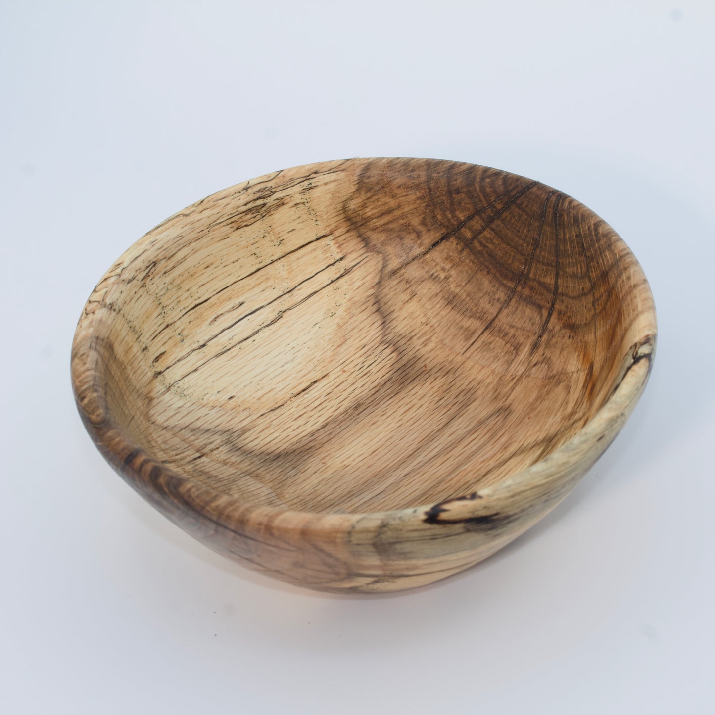 Wooden bowl with a natural finish on a white background