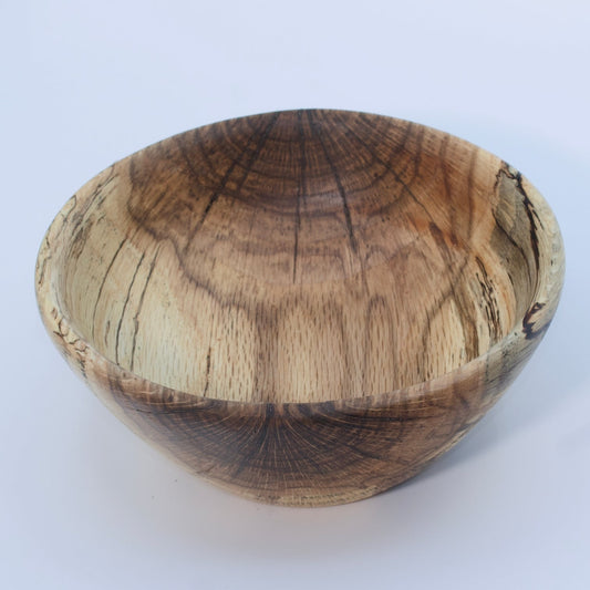 Wooden bowl with a natural, textured surface on a white background