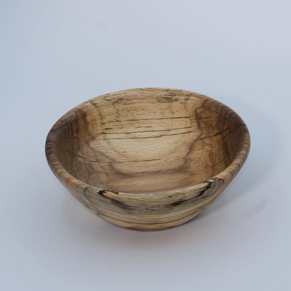 Wooden bowl with a natural, textured surface on a white background