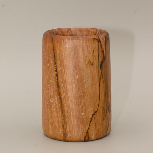 Spalted maple wood shot glass against white background