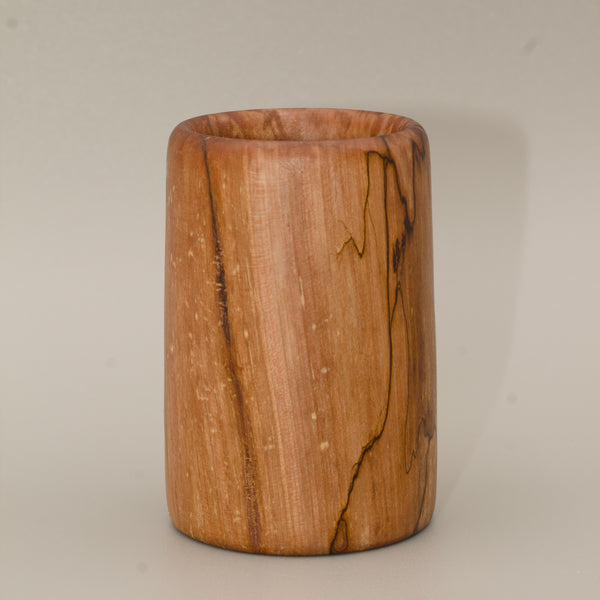 Spalted maple wood shot glass against white background