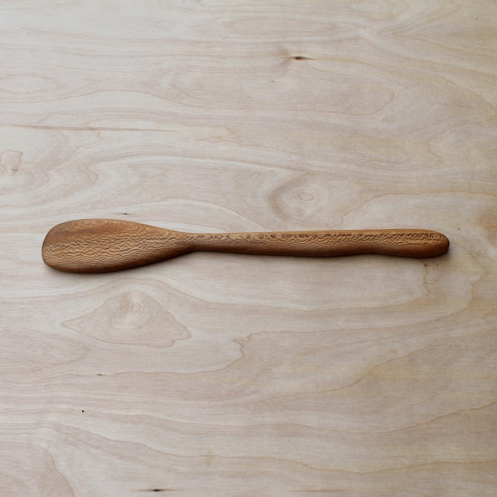 Wooden spoon on a light wooden surface