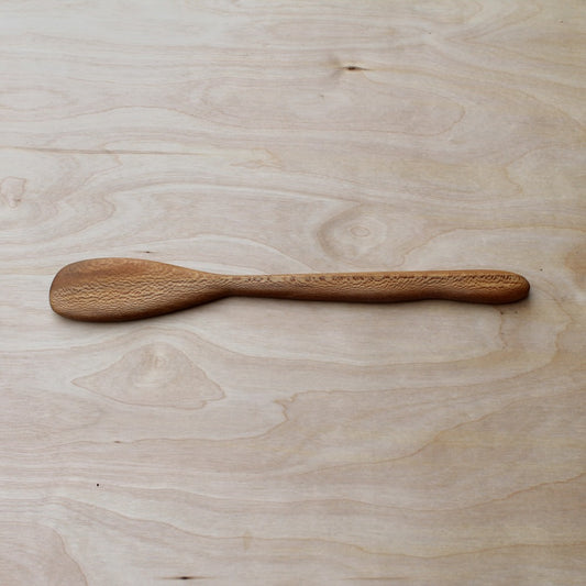 Wooden spoon on a light wooden surface