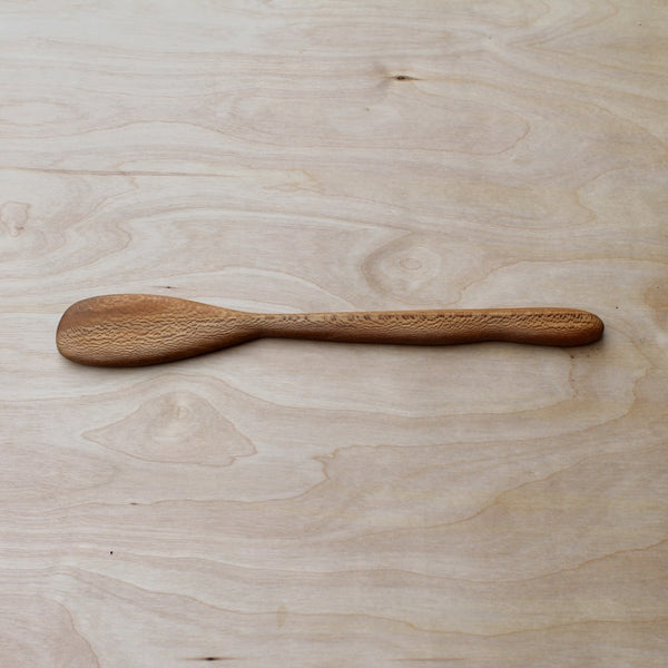 Wooden spoon on a light wooden surface