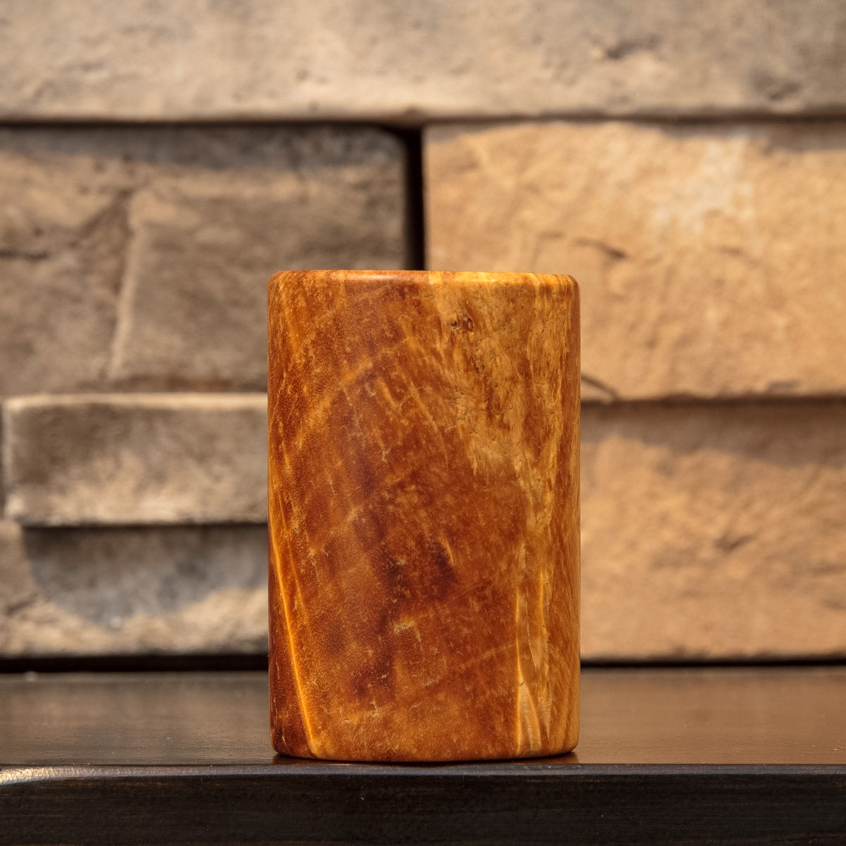 The Caramel Canyon stabilized Box Elder burl shot glass with swirling caramel and deep brown grain