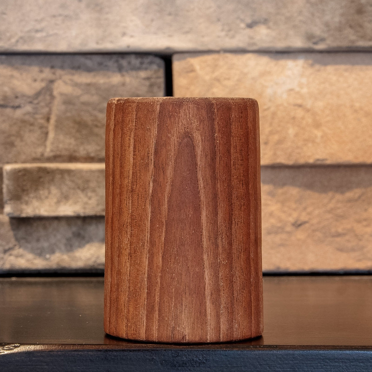 The Find walnut shot glass with curved grain figure centered on the exterior
