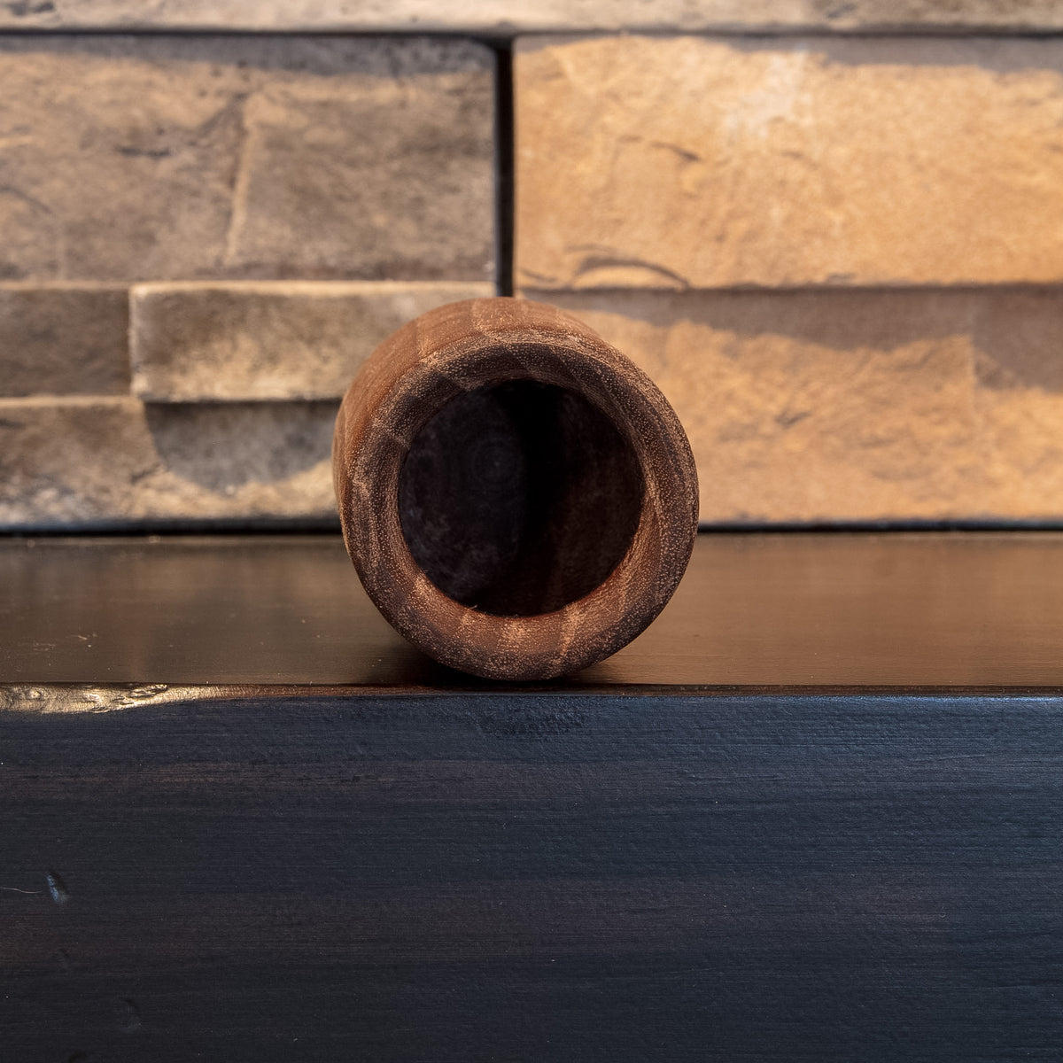 Top opening of The Find walnut shot glass showing the rounded rim and dark interior