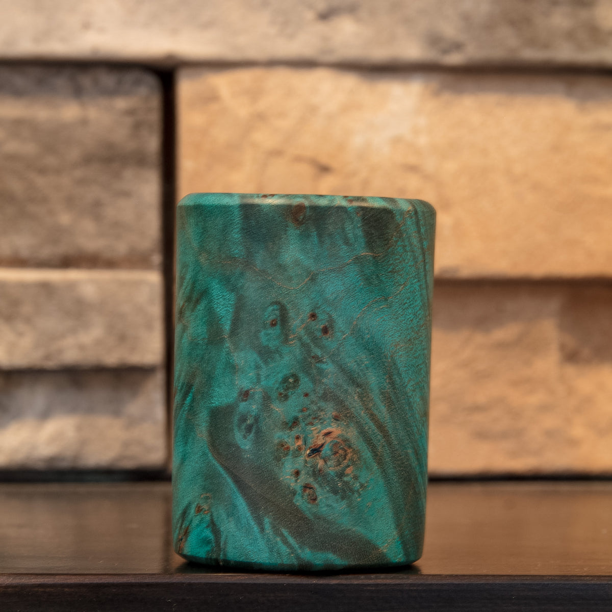 The Forgotten Current green-dyed stabilized Mappa Burl shot glass showing sweeping dark and turquoise burl figure