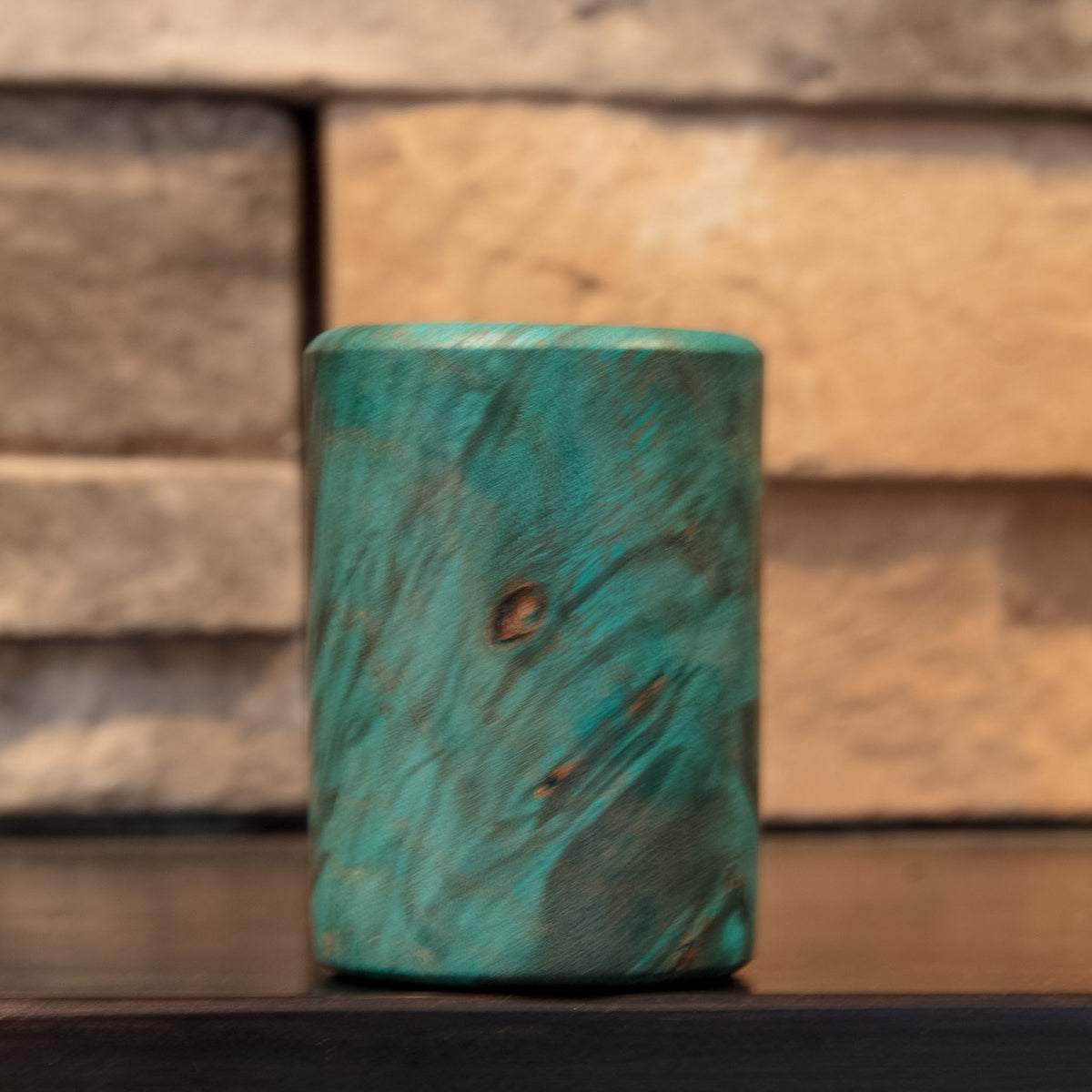 Alternate exterior of The Forgotten Current showing turquoise grain, dark figure, and natural burl-eye detail