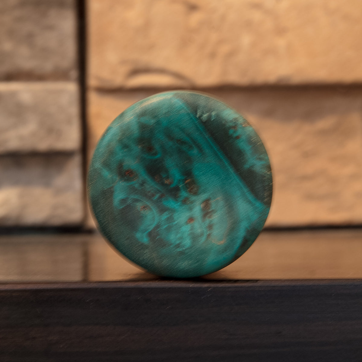 Bottom of The Forgotten Current shot glass showing turquoise end grain and clustered natural burl eyes