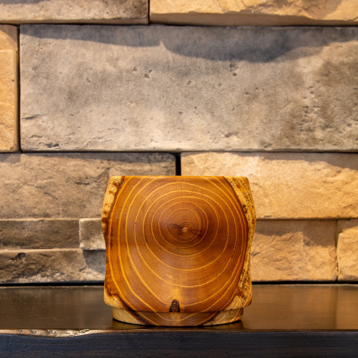 Opposite face of The Gathered Thread showing concentric White Mulberry heartwood rings and a small dark feature near the foot