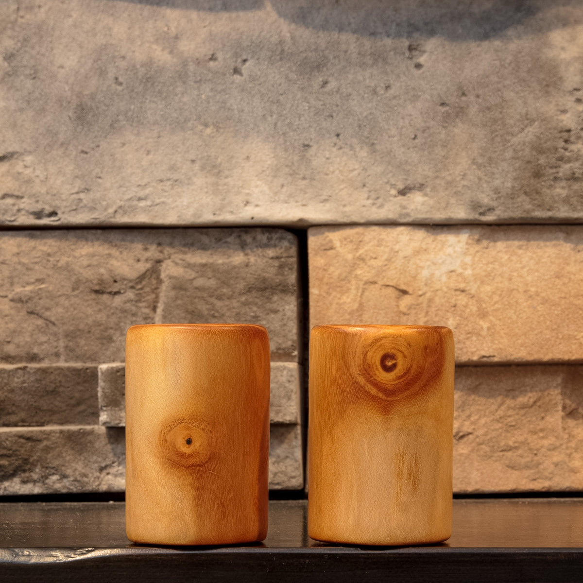 The Golden Orchard pair of hand-turned White Mulberry shot glasses, front view showing golden wood grain and natural knot details