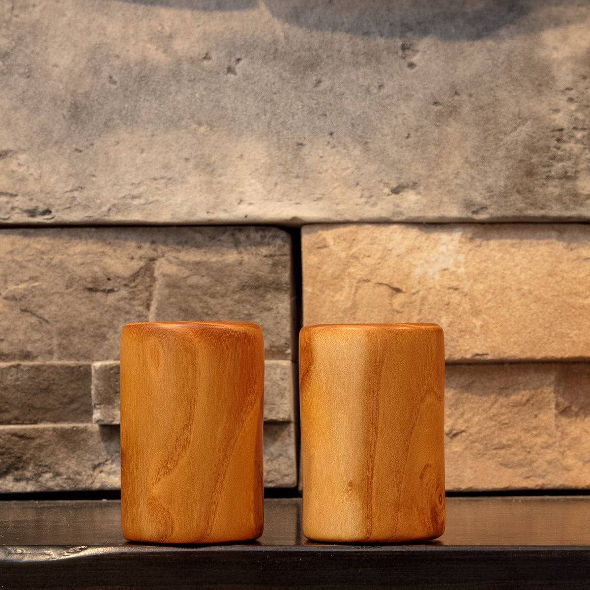 Side view of The Golden Orchard White Mulberry shot glass pair showing flowing vertical grain across both hand-turned pieces