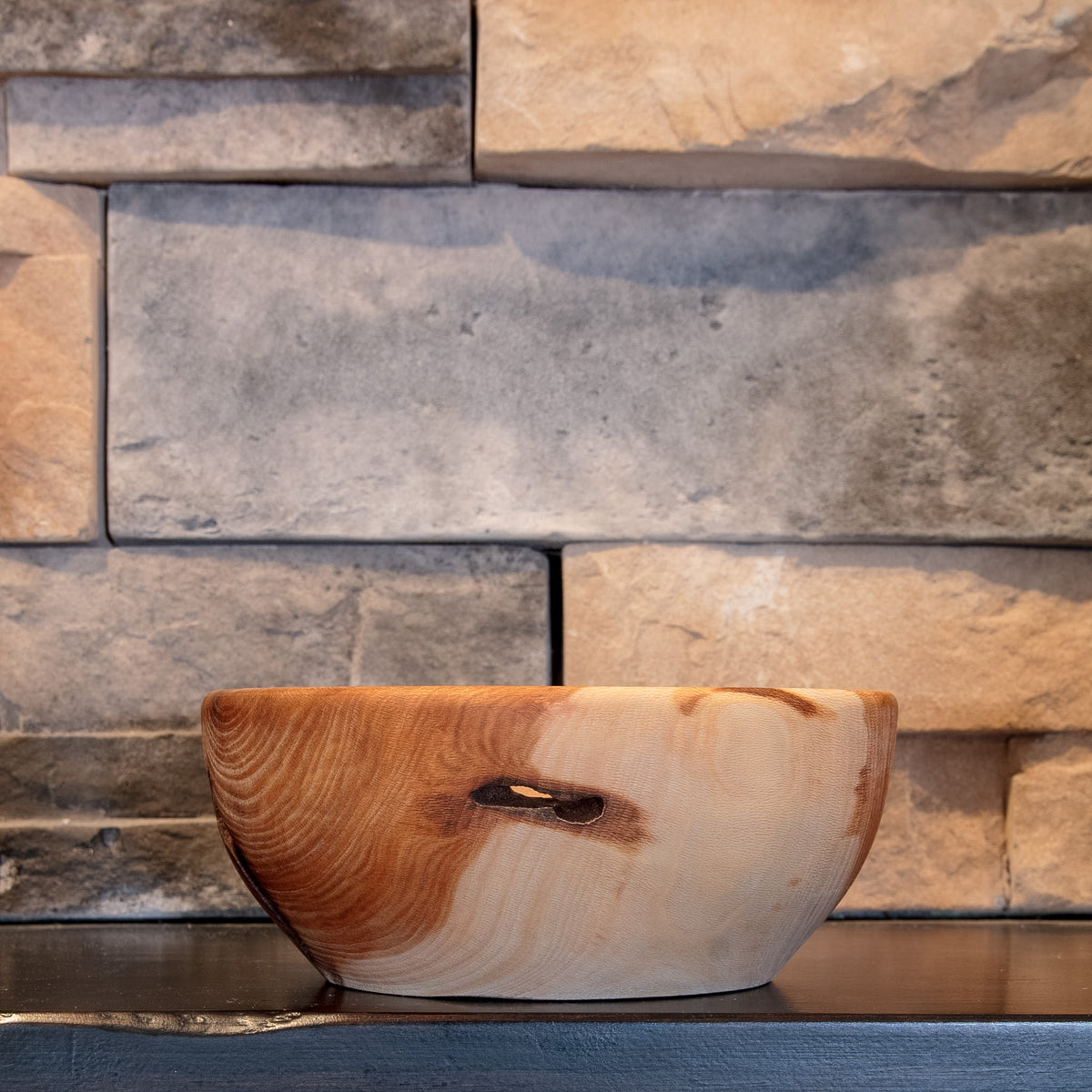 The Space Between Sycamore bowl showing a horizontal natural through-void across the pale-and-reddish exterior