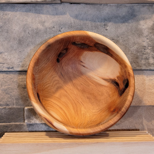 Interior of The Space Between Sycamore bowl showing sweeping grain and natural openings through the wall