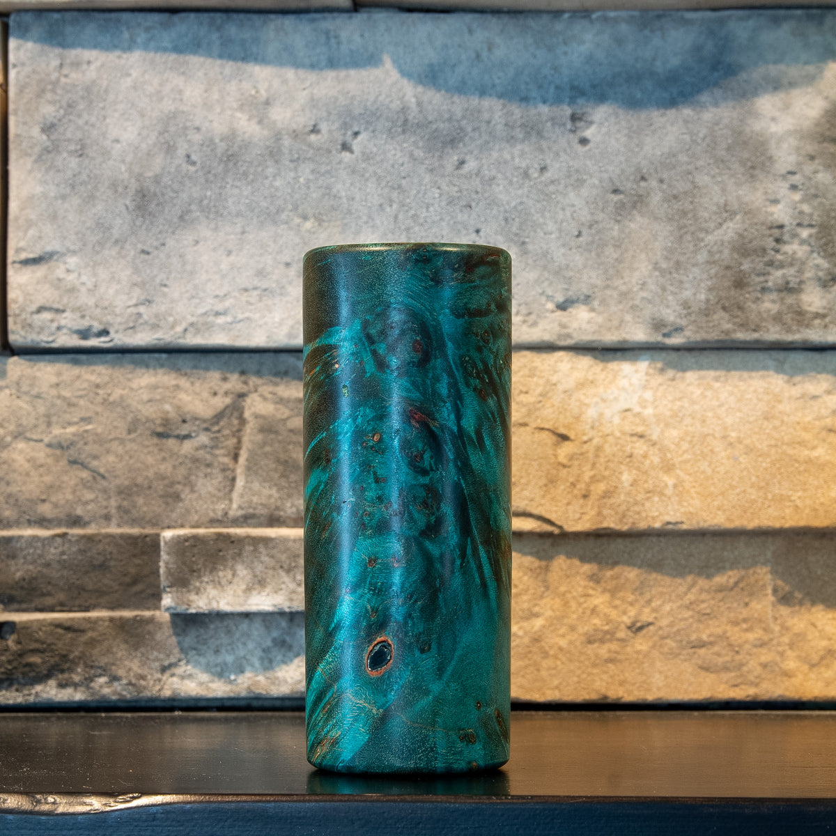 The Verdant Spire Mappa burl shot glass showing a prominent natural inclusion and teal figure