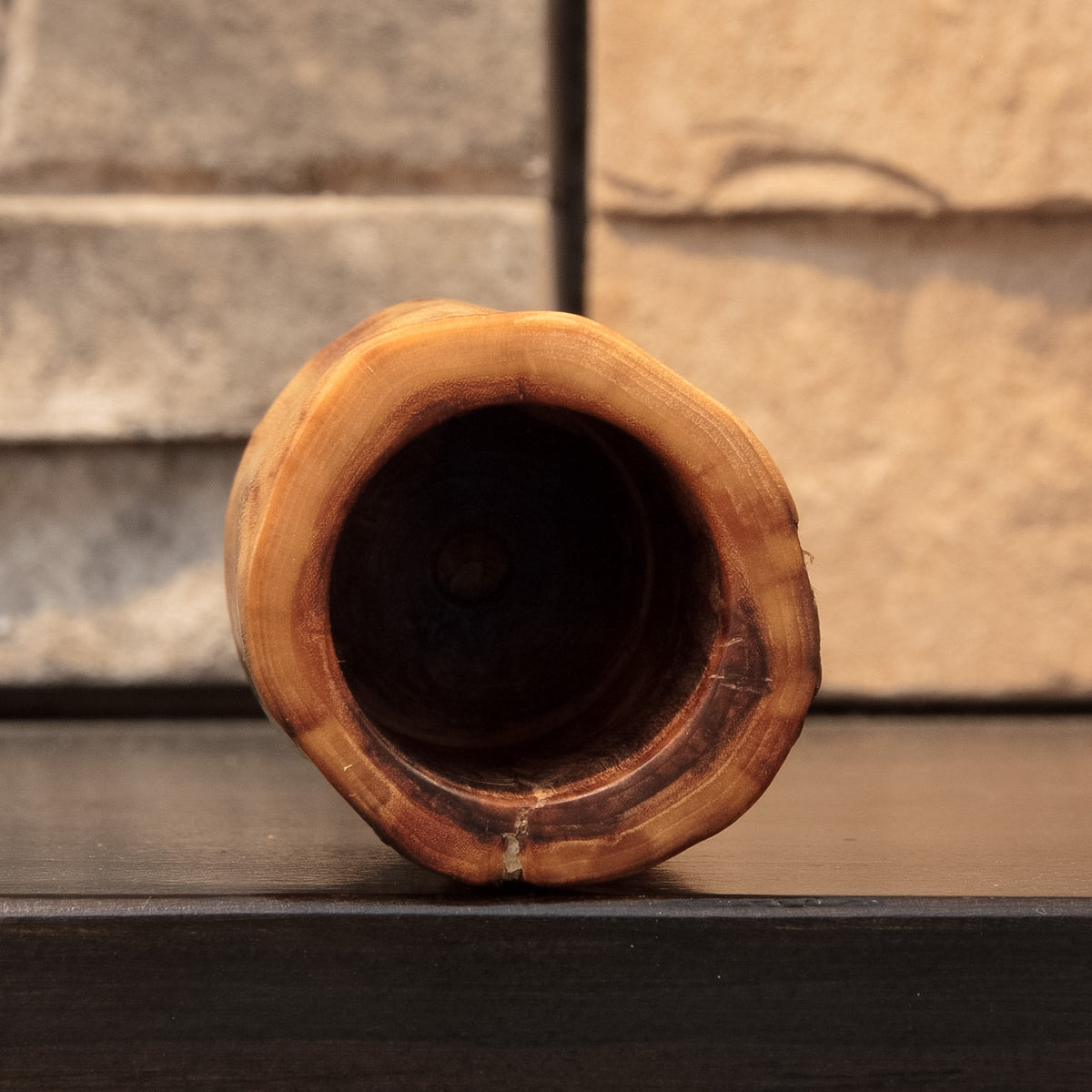 Top view into The Wild Branch cottonwood shot glass showing the dark hollowed interior and irregular natural-edge rim.