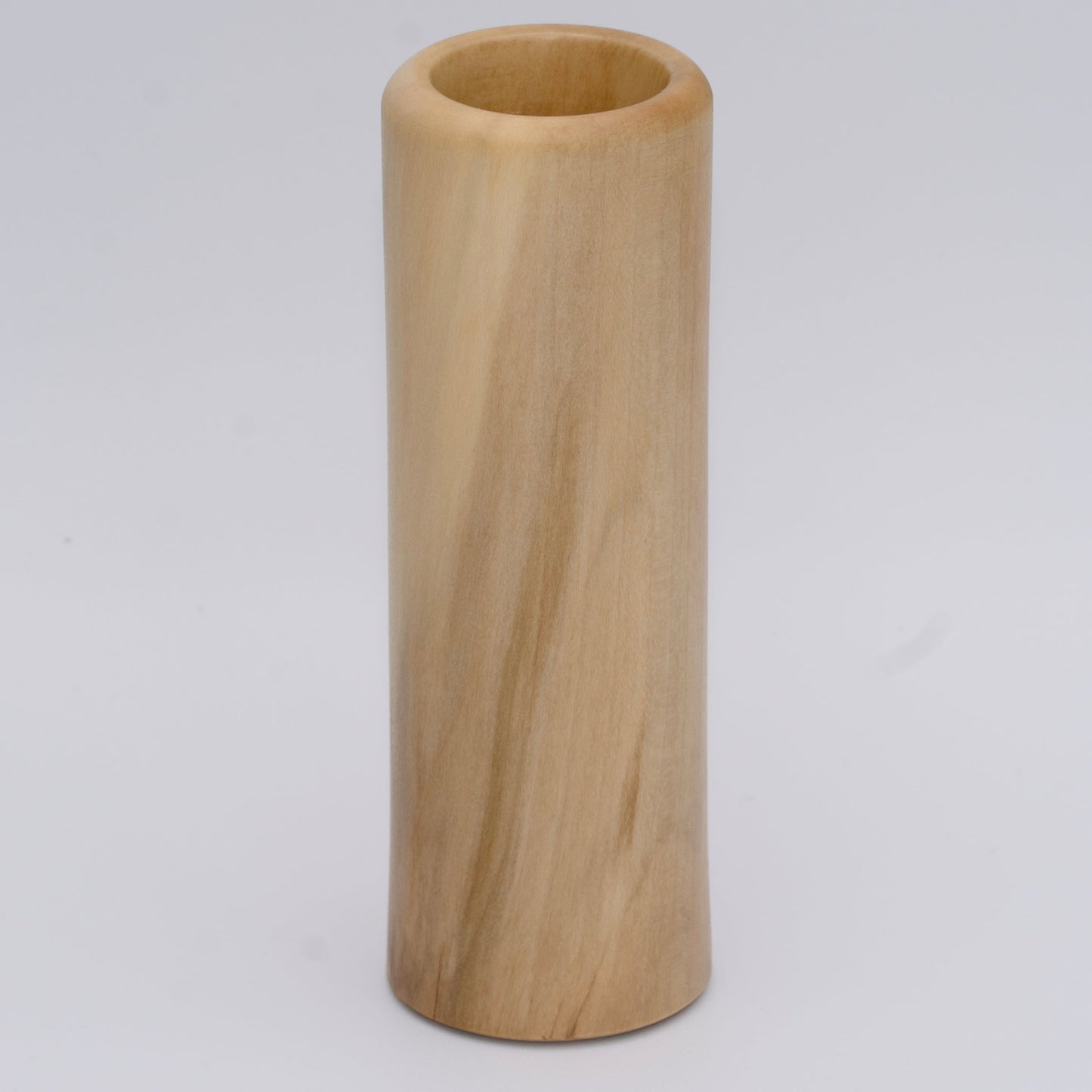 Tall Sweetgum wood shot glass against white background