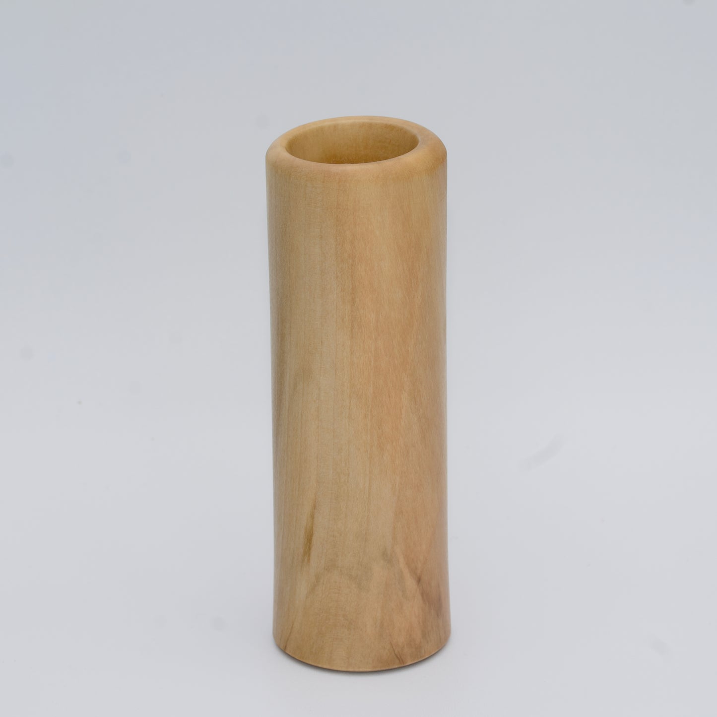 Tall Sweetgum wood shot glass against white background