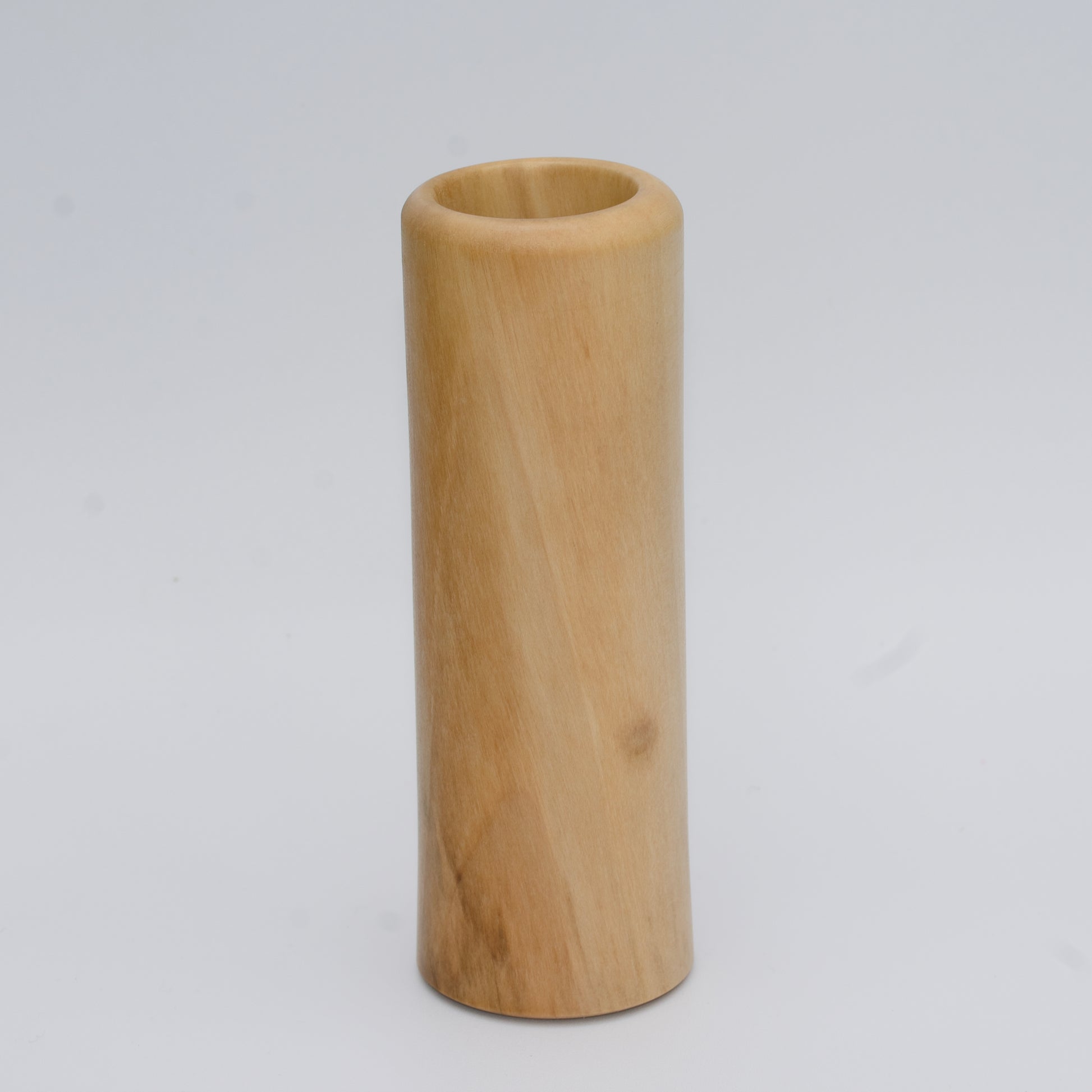 Tall Sweetgum wood shot glass against white background