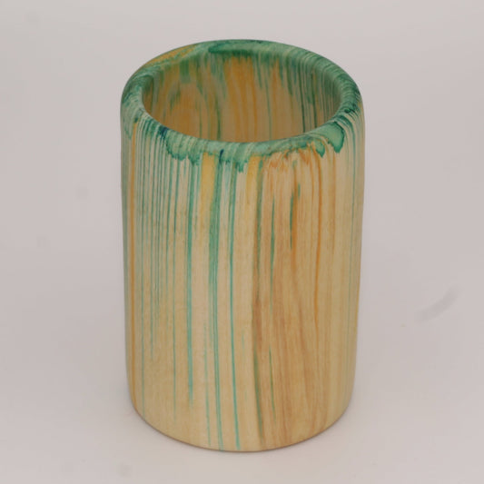 Multicolored aspen wood shot glass against white background