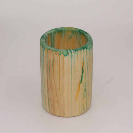 Multicolored aspen wood shot glass against white background