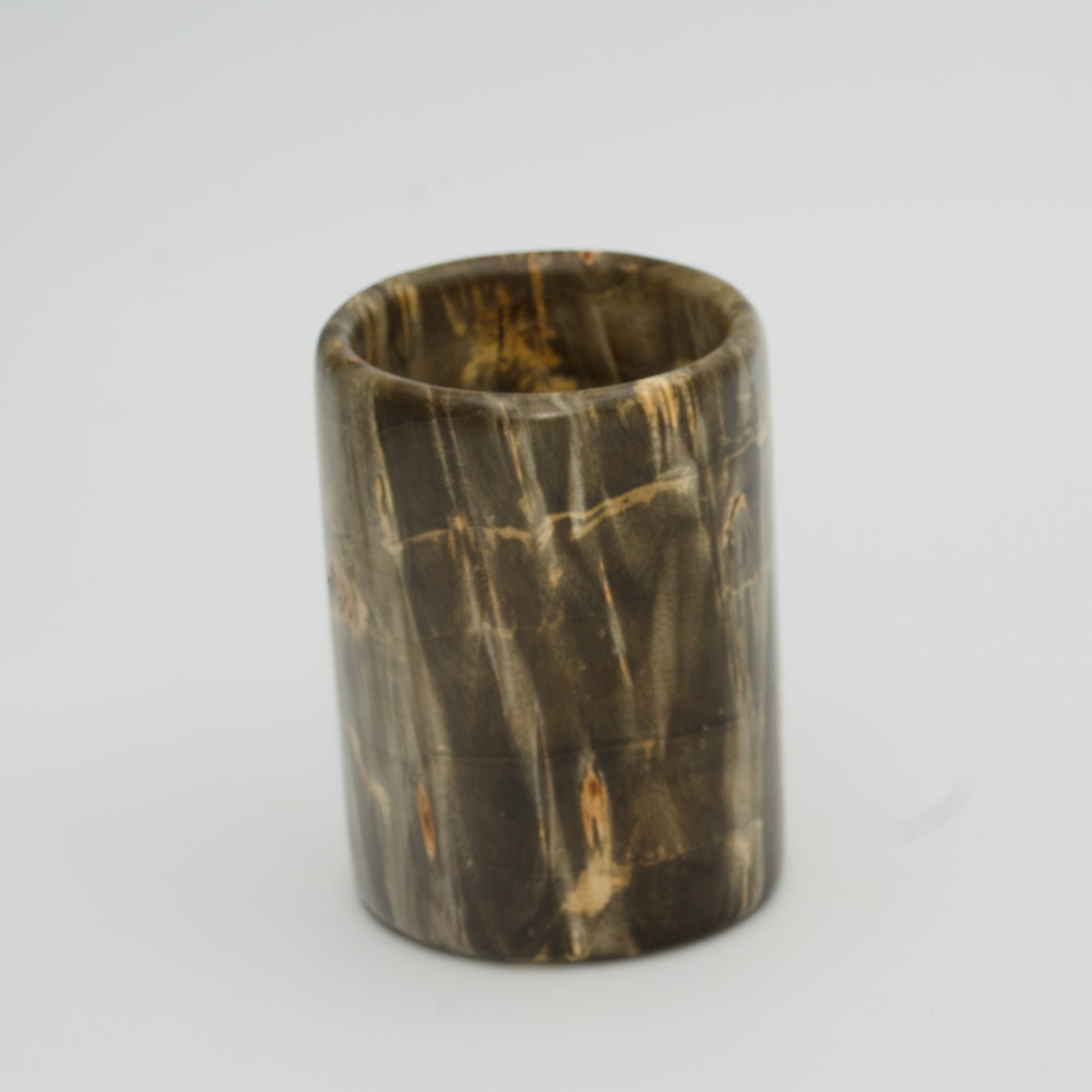 Green boxer elder burl shot glass against white background
