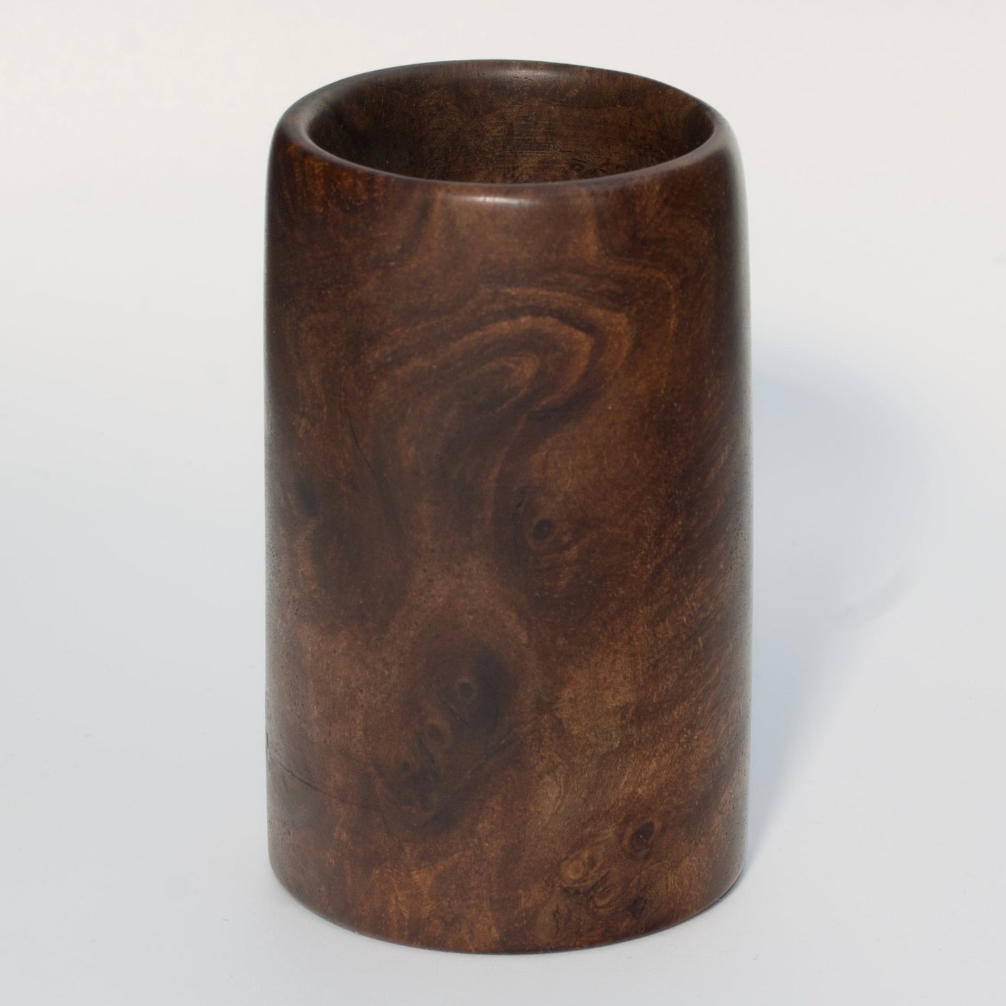 Walnut burl wood shot glass on white background