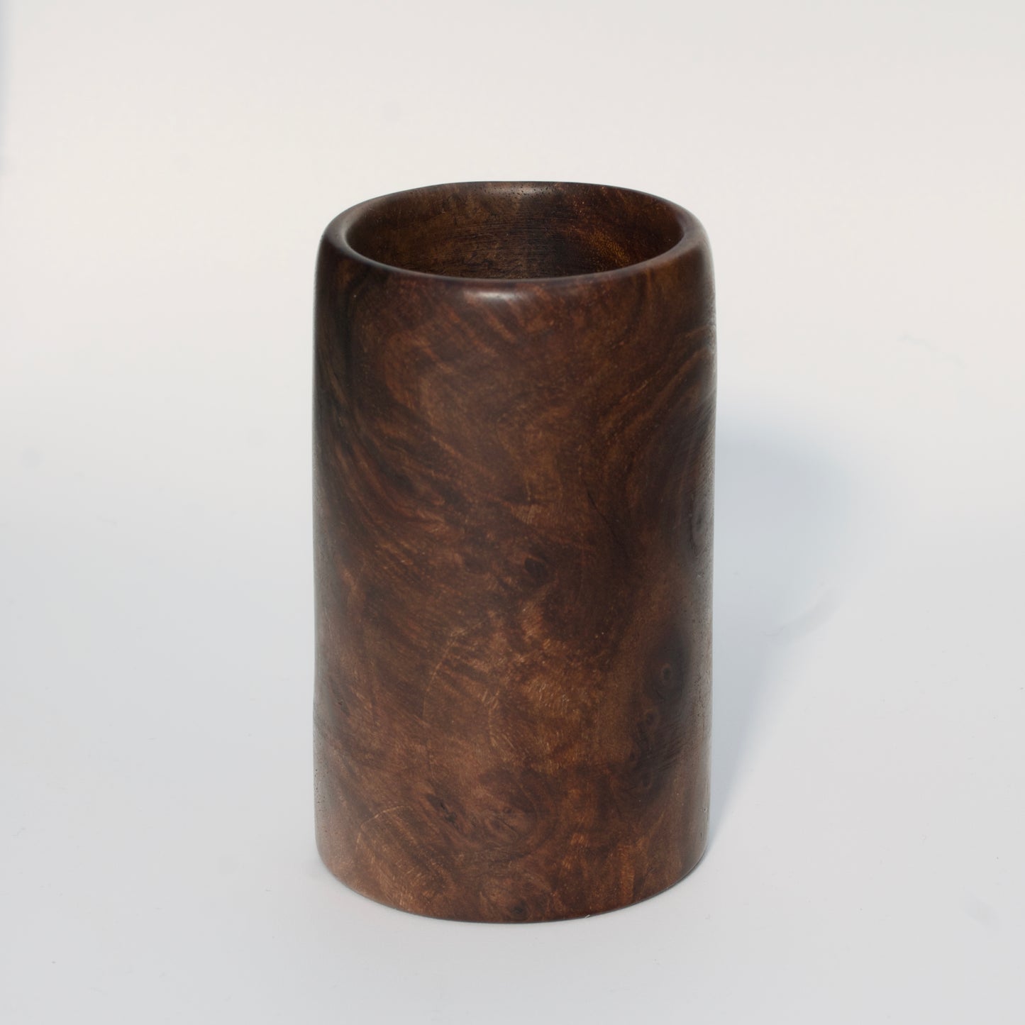 Walnut burl wood shot glass on white background
