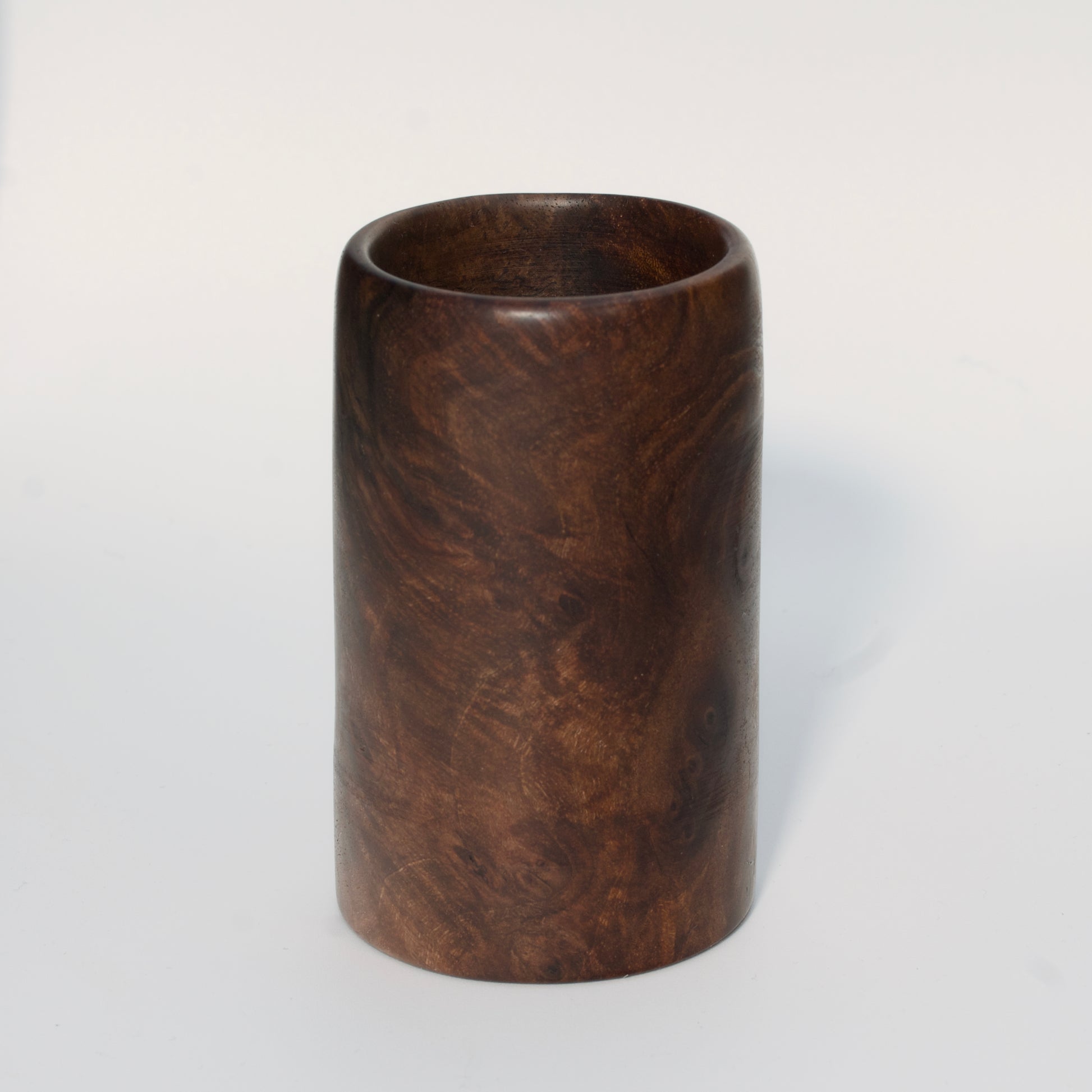 Walnut burl wood shot glass on white background