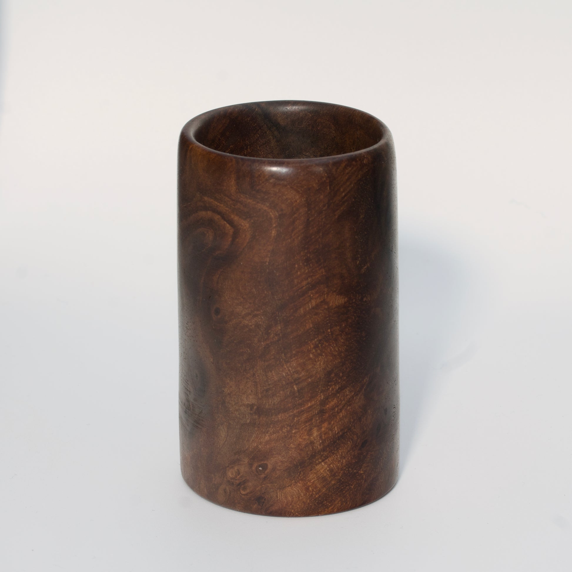 Walnut burl wood shot glass on white background