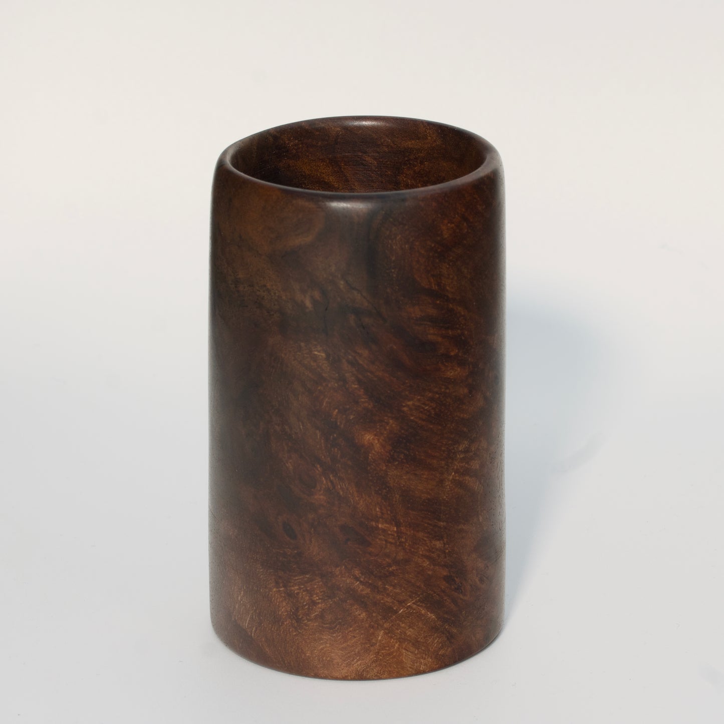 Walnut burl wood shot glass on white background