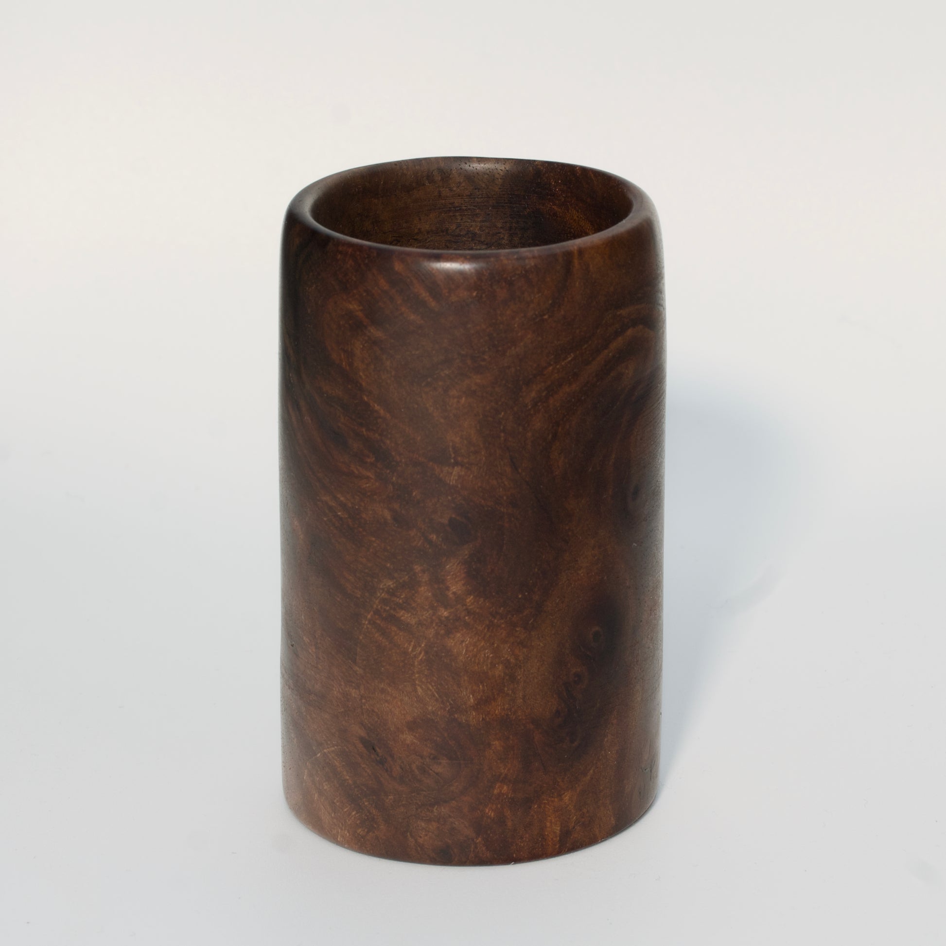 Walnut burl wood shot glass on white background
