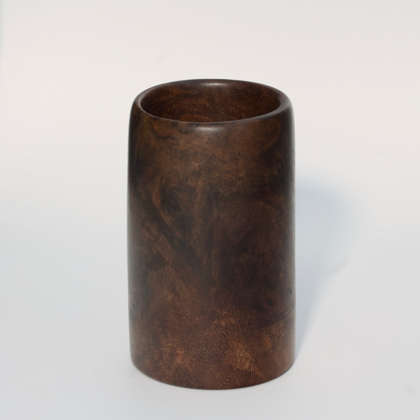 Walnut burl wood shot glass on white background
