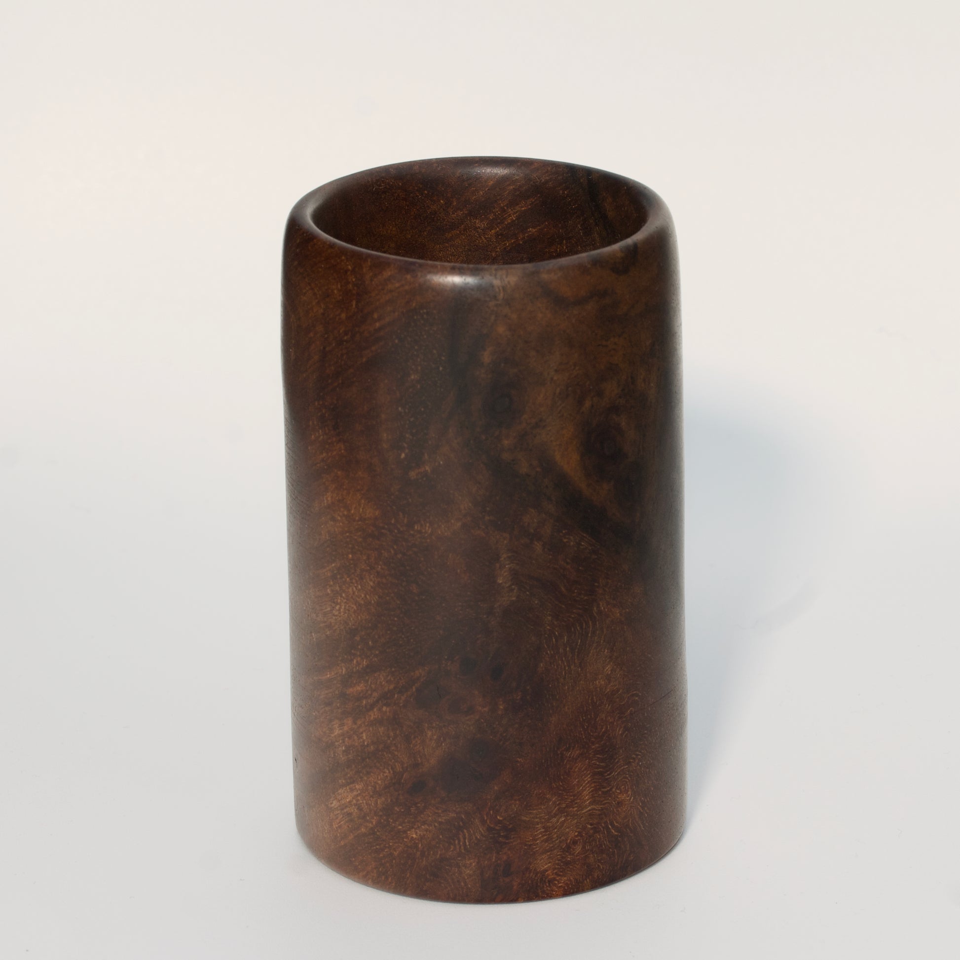 Walnut burl wood shot glass on white background