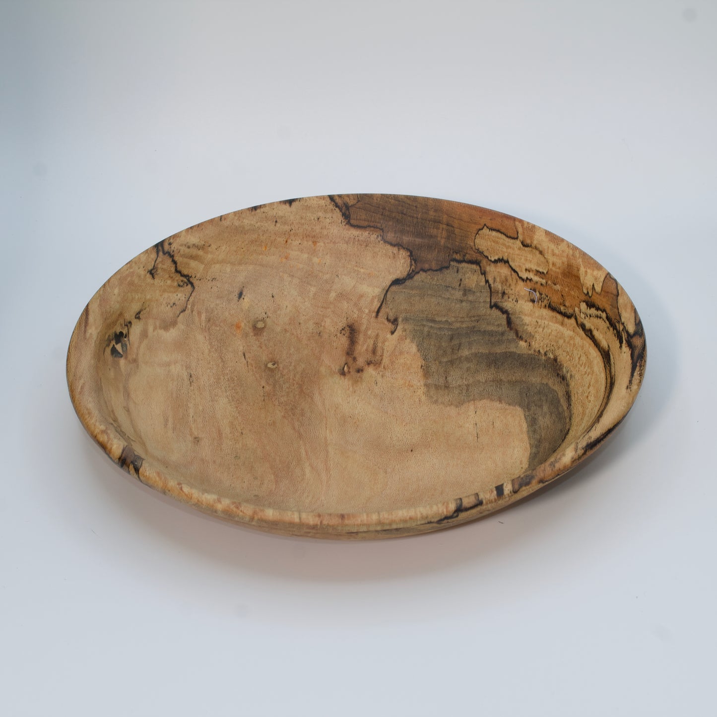 Wooden bowl with marbled pattern on a white background