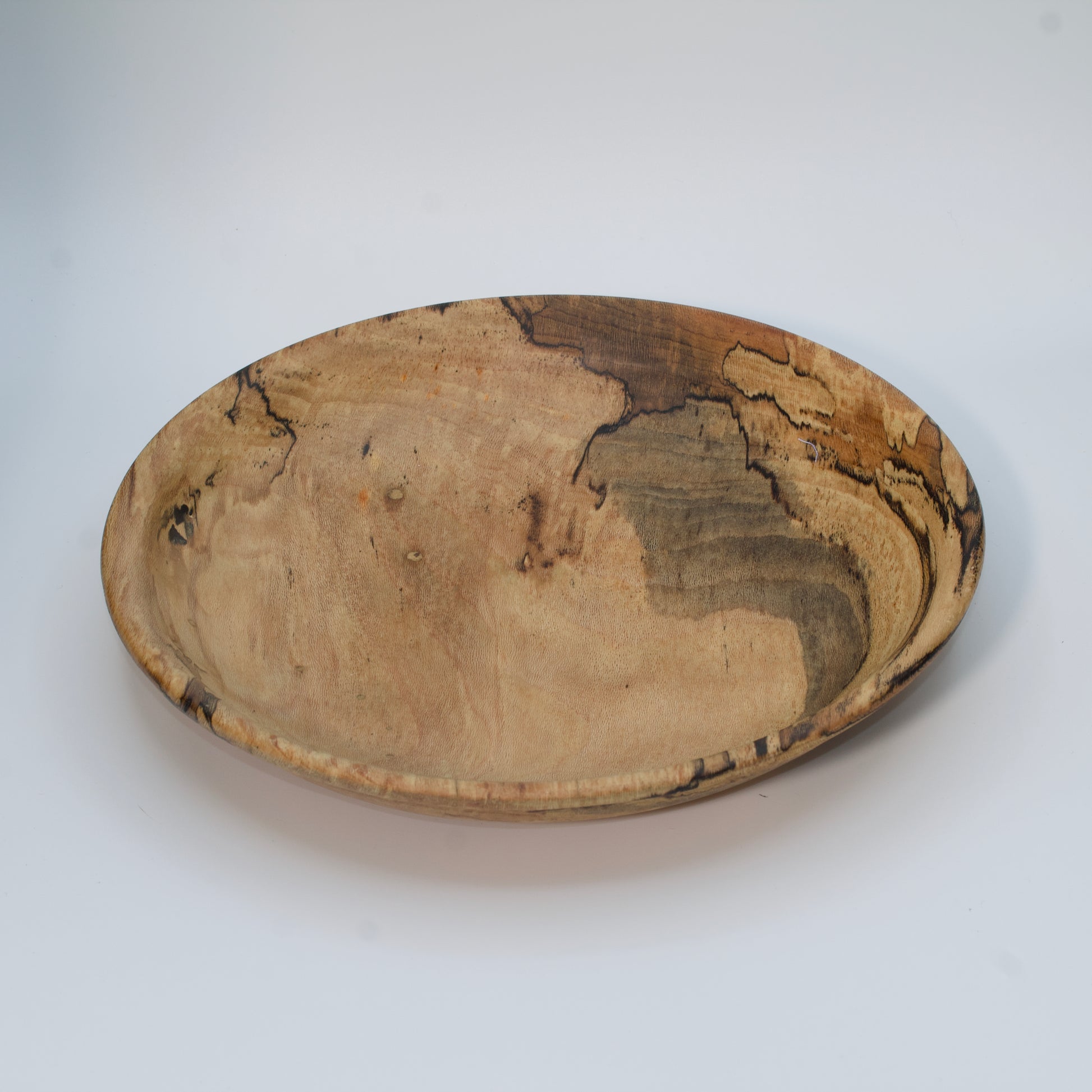 Wooden bowl with marbled pattern on a white background