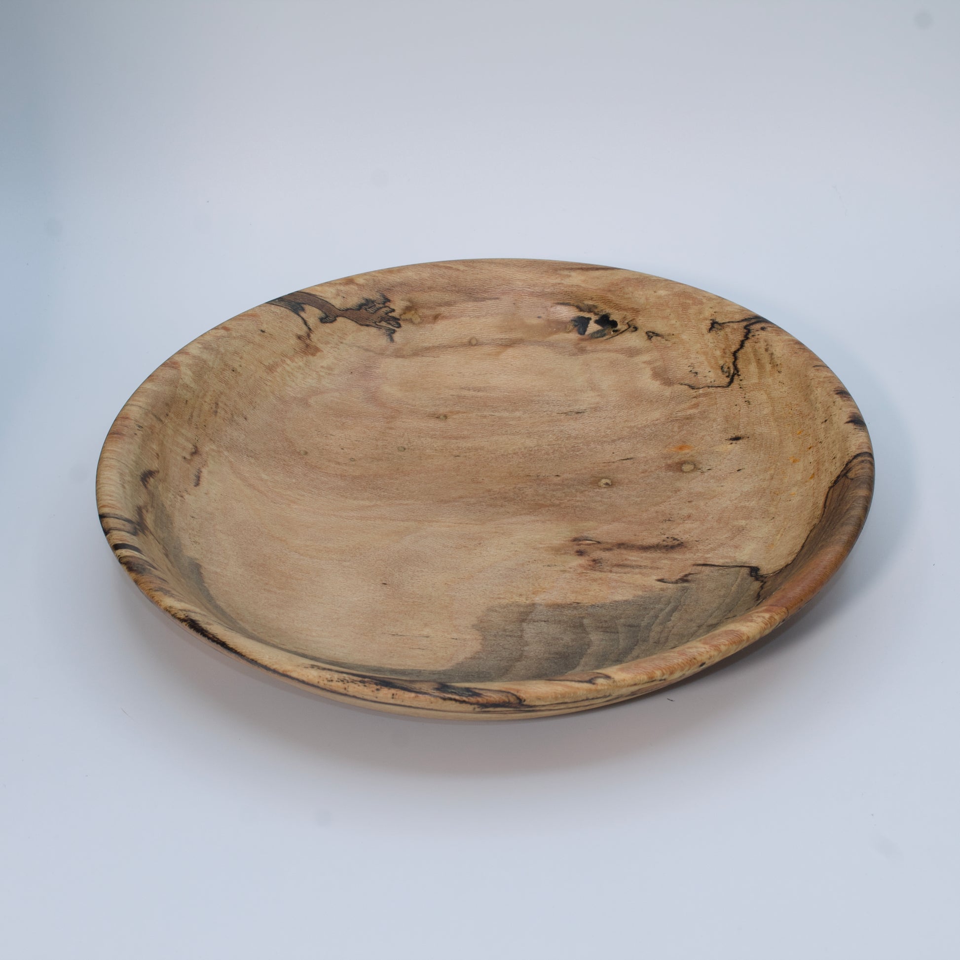 Wooden bowl with marbled pattern on a white background