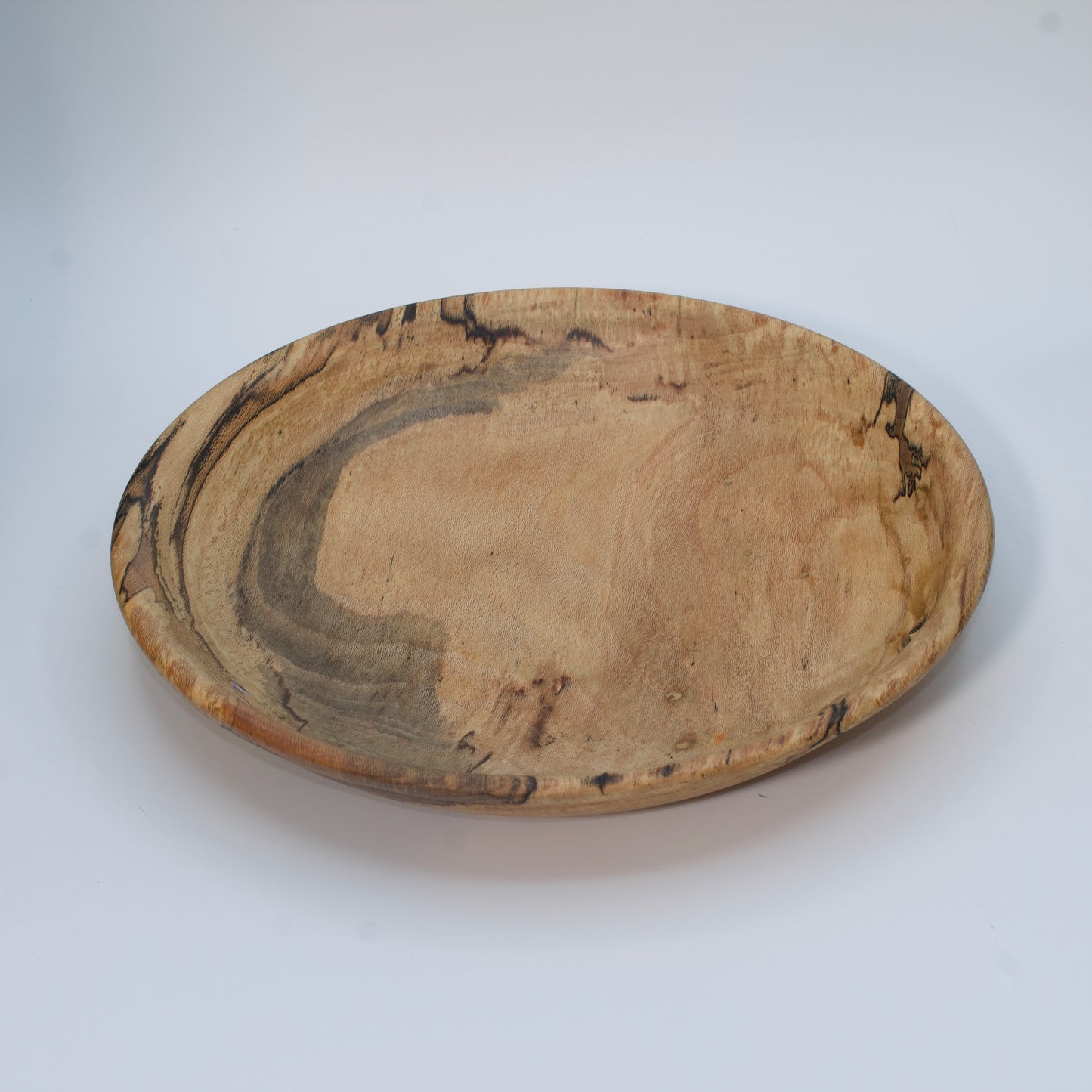 Wooden bowl with marbled pattern on a white background