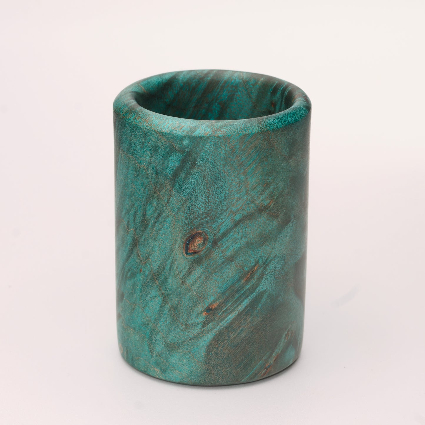 Green dyed Mappa Burl shot glass against white background