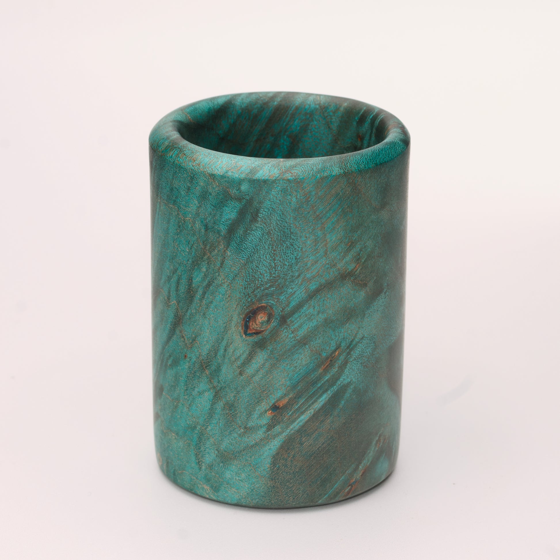 Green dyed Mappa Burl shot glass against white background