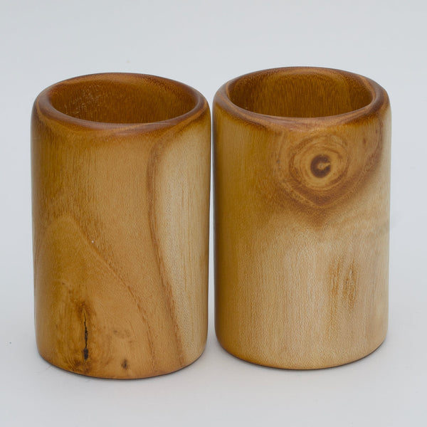 Pair of white mulberry shot glasses with orange glow