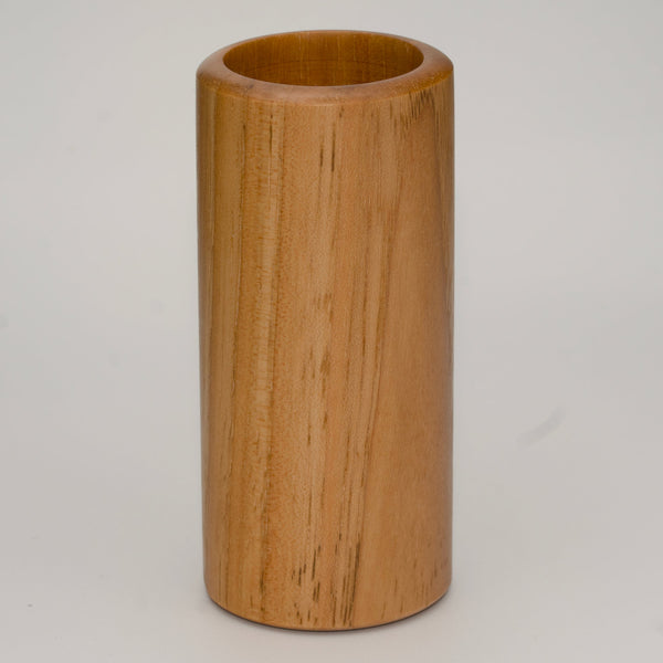 Tall pecan wood shot glass against white background