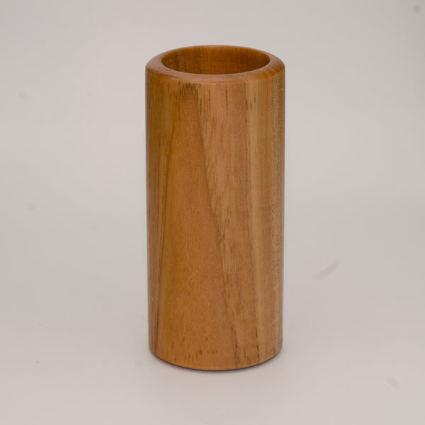 Tall pecan wood shot glass against white background