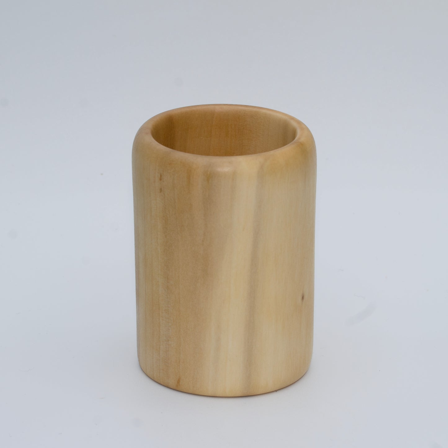 Sweetgum wood shot glass against white background