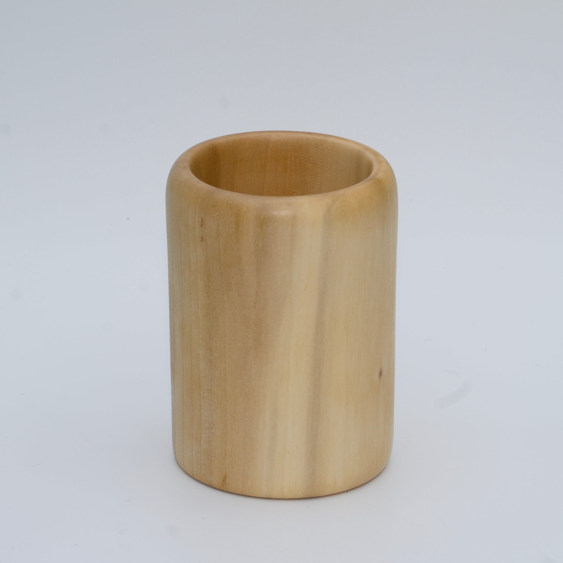 Sweetgum wood shot glass against white background
