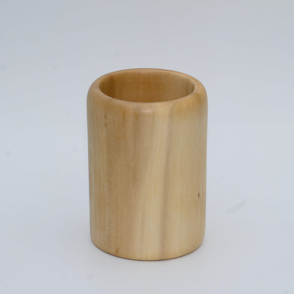 Sweetgum wood shot glass against white background