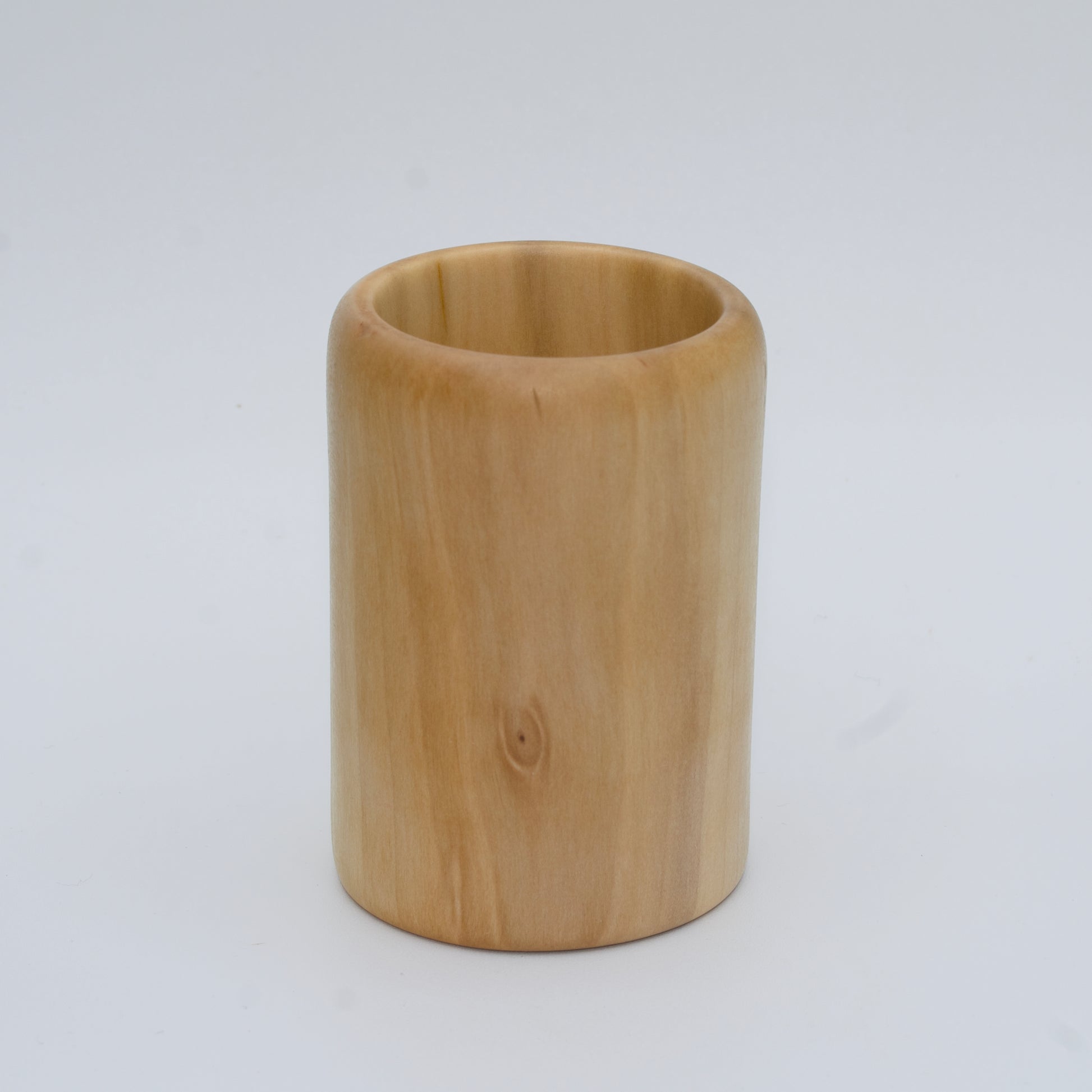 Sweetgum wood shot glass against white background