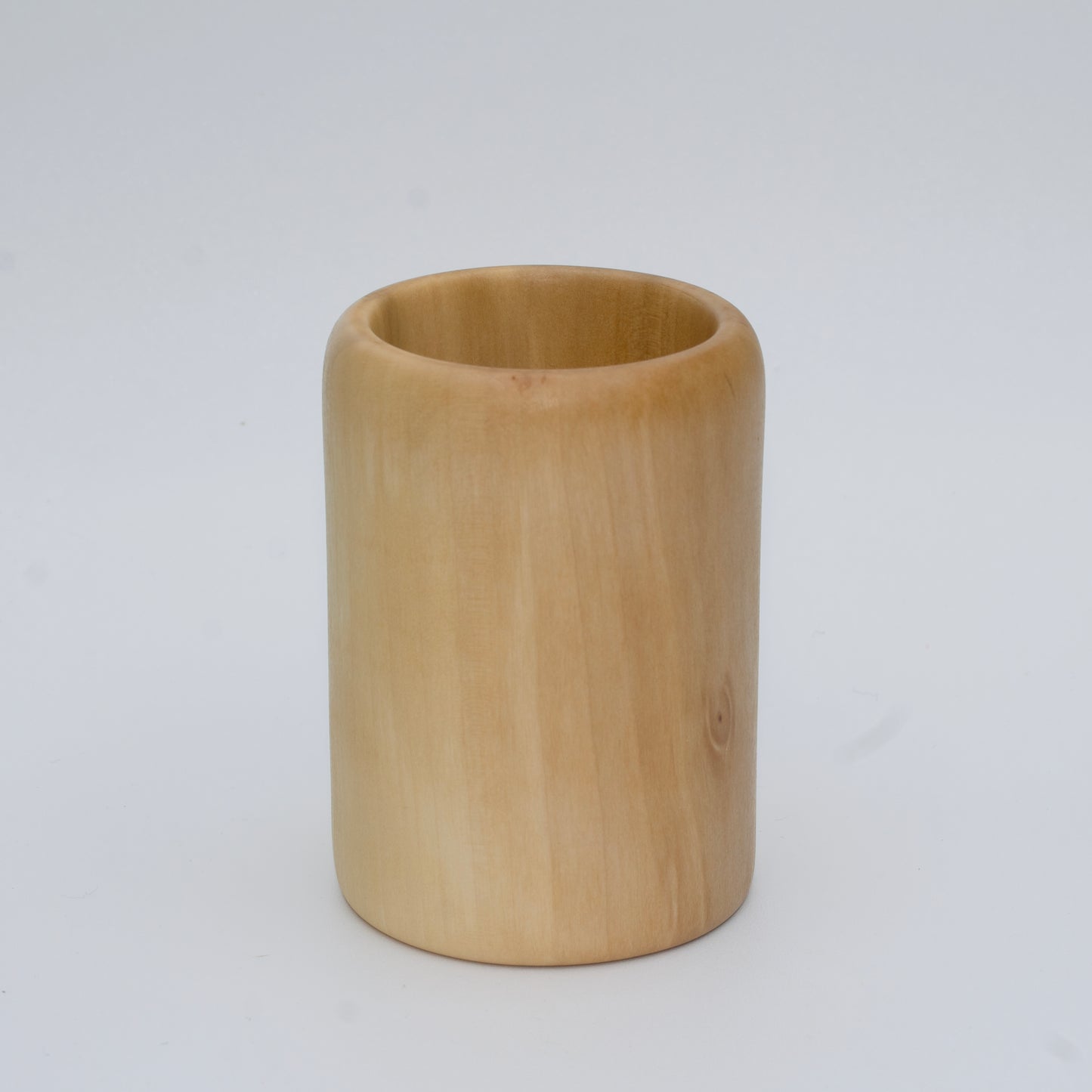 Sweetgum wood shot glass against white background